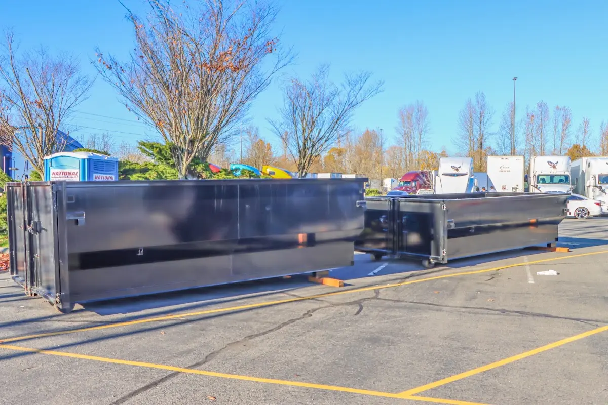 Professional dumpster rental service with roll-off container on residential driveway in Westampton